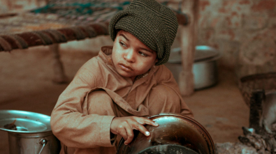 boy holding stock pot