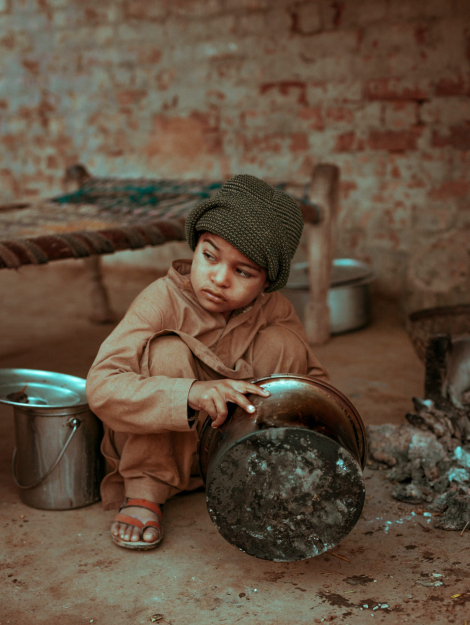 boy holding stock pot