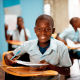 boy holding white paper