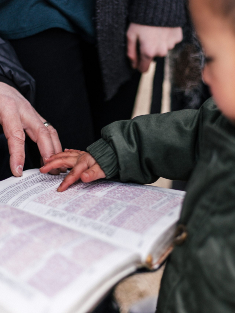 boy touching page of book